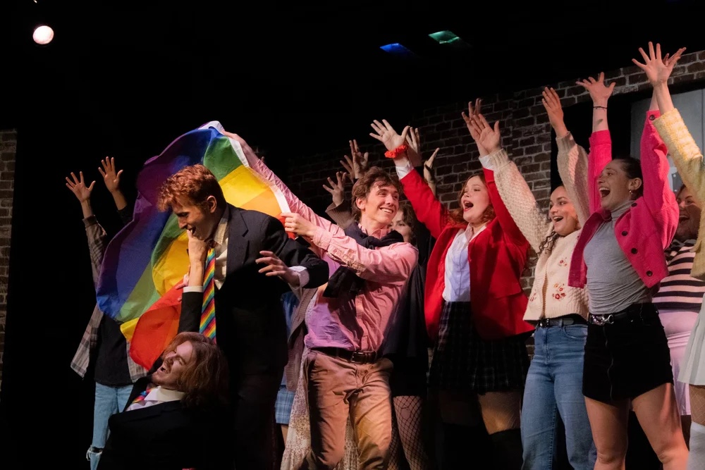 Heathers — key production image, lit on scroll.